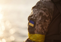 the Ukrainian flag in the form of a chevron on the hand of a military man - PhotoDune Item for Sale