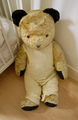 Vintage old large stuffed teddy bear sitting on the floor - PhotoDune Item for Sale
