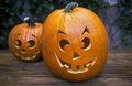 Pair of smiling Halloween pumpkins in the garden close up - PhotoDune Item for Sale