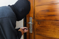 Thief burglar opening wooden door  - PhotoDune Item for Sale