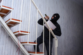 Masked burglar with flashlight stealing laptop - PhotoDune Item for Sale