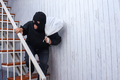 Burglar man walking down the stairs stealing goods - PhotoDune Item for Sale