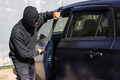 Thief stealing automobile car, try to open the door.  - PhotoDune Item for Sale