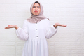 Doubtful Asian muslim woman having clueless and confused expression with arms and hands raised - PhotoDune Item for Sale
