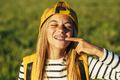 Portrait of beautiful young blonde girl in a yellow cap and a bracket on her teeth. - PhotoDune Item for Sale