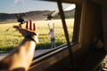 The happy girl has fun on a wonderful camping day. Van life concept. - PhotoDune Item for Sale