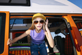 The happy girl has fun on a wonderful camping day. Van life concept. - PhotoDune Item for Sale