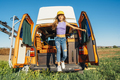 The happy girl has fun on a wonderful camping day. Van life concept. - PhotoDune Item for Sale