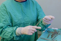 Surgeon, wearing medical protective gloves skillfully maneuvered sterile forceps needle holder - PhotoDune Item for Sale