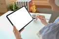 Close up view of creative woman hand pointing at blank display of digital tablet. - PhotoDune Item for Sale