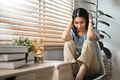 Unhappy young woman holding her head, suffering from depression. - PhotoDune Item for Sale