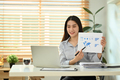 Confident young businesswoman making virtual online presentation via laptop computer. - PhotoDune Item for Sale