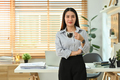 Young asian woman entrepreneur standing near working desk in a modern office - PhotoDune Item for Sale