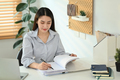 Concentrated female worker signing contracts at her working desk. - PhotoDune Item for Sale