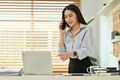 Asian female investment advisor consulting client and using laptop at workplace. - PhotoDune Item for Sale