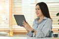 Attractive asian female marketing business manager using digital tablet at working desk - PhotoDune Item for Sale