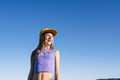 Outdoor portrait of a beautiful young blonde woman in a yellow cap and a bracket on her teeth. - PhotoDune Item for Sale