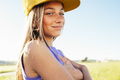 Outdoor portrait of a beautiful young blonde woman in a yellow cap and a bracket on her teeth. - PhotoDune Item for Sale