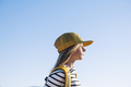 Outdoor portrait of a beautiful young blonde woman in a yellow cap and a bracket on her teeth. - PhotoDune Item for Sale