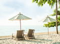 Chair Beach and Umbrella on Sand at Coast with blur Blue Sea and Cloud Sky Background - PhotoDune Item for Sale
