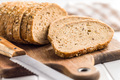 Sliced whole grain bread. Tasty wholegrain pastry with seeds on cutting board. - PhotoDune Item for Sale