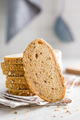 Sliced whole grain bread. Tasty wholegrain pastry with seeds on checkered napkin. - PhotoDune Item for Sale