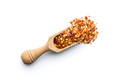Dry chili pepper flakes in wooden scoop. Crushed red peppers isolated on white background. - PhotoDune Item for Sale