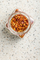 Dry chili pepper flakes. Crushed red peppers in jar on white table. Top view. - PhotoDune Item for Sale