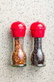 Dry chili pepper flakes. Crushed red peppers in mill on kitchen table. Top view. - PhotoDune Item for Sale