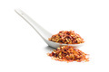 Chili pepper flakes in ceramic spoon. Crushed red peppers isolated on white background. - PhotoDune Item for Sale
