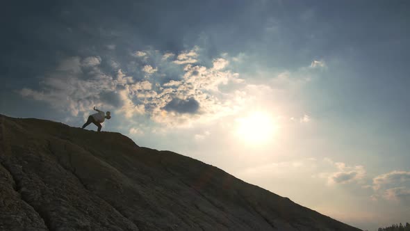 A Boy on Top of a Mountain Performs a Freestyle Football