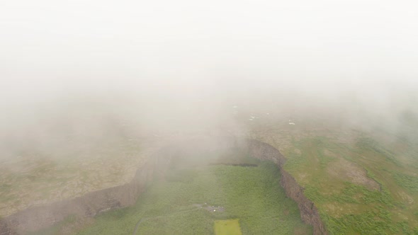 Scenic Asbyrgi Glacial Canyon Under Clouds In Iceland - aerial drone shot