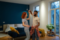 Happy romantic multiracial young couple in love learning to dance together at home - PhotoDune Item for Sale