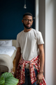 Domestic portrait of bearded African American guy in casual clothes standing in modern apartment - PhotoDune Item for Sale