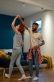 Loving young diverse couple dancing romantic dance in modern bedroom with panoramic windows. - PhotoDune Item for Sale