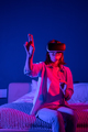 Young amazed millennial girl wearing metaverse VR headset touching objects in virtual world - PhotoDune Item for Sale