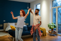 Happy romantic multiracial young couple in love learning to dance together at home - PhotoDune Item for Sale