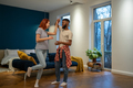 Loving young diverse couple dancing romantic dance in modern bedroom with panoramic windows. - PhotoDune Item for Sale