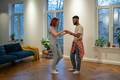Young diverse couple in love preparing first wedding dance together at home - PhotoDune Item for Sale