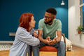 Unhappy serious interracial couple young man and woman talking about relationships at home - PhotoDune Item for Sale