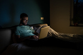 Black guy freelance IT developer using laptop at night, coding until late hours to meet deadline - PhotoDune Item for Sale