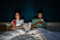 Young multiracial couple lying in bed using smartphones not talking - PhotoDune Item for Sale