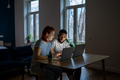 Young interracial couple looking at laptop discussing online family business, working late at home - PhotoDune Item for Sale