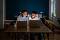 Young diverse couple running small online business at home, man and woman working on laptops - PhotoDune Item for Sale