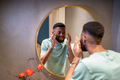 African American man looking at reflection in mirror and smiling - PhotoDune Item for Sale