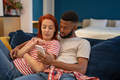 Young millennial diverse couple man and woman resting at home with mobile phone - PhotoDune Item for Sale