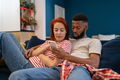 Young millennial diverse couple man and woman resting at home with mobile phone - PhotoDune Item for Sale