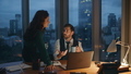 Colleagues discussing work drinking coffee at office late evening. Two partners. - PhotoDune Item for Sale