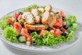 Delicious Caesar salad with tomatoes and olives and lettuce. - PhotoDune Item for Sale