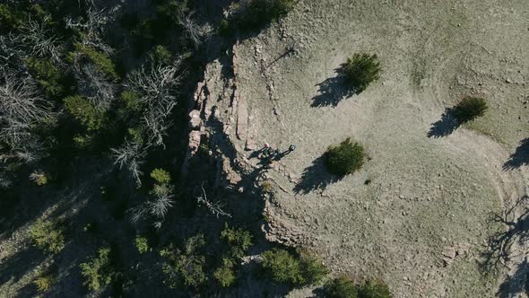 group of people hiking on top of a cliff in wyoming